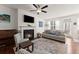 Bright living room with a cozy fireplace, piano, and comfortable seating area at 61 N Auburn Landing Pl, Auburn, GA 30011