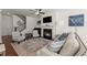 Open living room with a fireplace, television, stairs, and comfortable seating at 61 N Auburn Landing Pl, Auburn, GA 30011