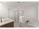 Bright main bathroom with a soaking tub, glass-enclosed shower, and double vanity at 61 N Auburn Landing Pl, Auburn, GA 30011