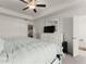Well-lit main bedroom features a ceiling fan, dresser, and access to the bathroom at 61 N Auburn Landing Pl, Auburn, GA 30011