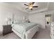 Comfortable main bedroom with a tray ceiling, fan, and neutral decor at 61 N Auburn Landing Pl, Auburn, GA 30011