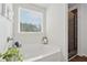Well-lit bathroom with a soaking tub and a shower with glass doors at 701 Woodward Ct, Canton, GA 30114