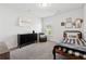 Neutral bedroom featuring a dark dresser, comfy chair, carpet floors, and a window at 701 Woodward Ct, Canton, GA 30114