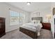 Cozy bedroom with a large window, soft carpet, and neutral decor for relaxation at 701 Woodward Ct, Canton, GA 30114