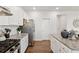 Modern kitchen featuring granite countertops, stainless steel appliances, and white cabinetry at 701 Woodward Ct, Canton, GA 30114