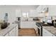 Modern kitchen features white cabinets, stainless steel appliances, and granite countertops at 701 Woodward Ct, Canton, GA 30114