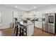 Well-lit kitchen with white cabinets, stainless steel appliances, and a center island at 701 Woodward Ct, Canton, GA 30114