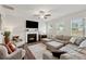 Cozy living room with a fireplace, a sectional sofa, and large windows at 701 Woodward Ct, Canton, GA 30114