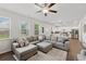 Open-concept living room with a large sectional sofa and ample natural light at 701 Woodward Ct, Canton, GA 30114
