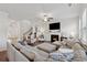 Comfortable living room featuring a fireplace, a large sofa, and a staircase at 701 Woodward Ct, Canton, GA 30114