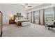 Spacious main bedroom with tray ceiling, large windows and an abundance of natural light at 701 Woodward Ct, Canton, GA 30114