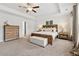 Bright main bedroom with tray ceiling, soft carpet and tasteful furniture at 701 Woodward Ct, Canton, GA 30114