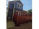 Exterior view of the back of the house with a large elevated deck and lush landscaping at 102 Neal Ave, Stockbridge, GA 30281
