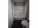 This bathroom features a shower and bathtub combo with dark tile flooring at 102 Neal Ave, Stockbridge, GA 30281