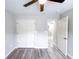 Spacious bedroom with gray flooring, ceiling fan, and ample closet space at 102 Neal Ave, Stockbridge, GA 30281