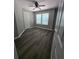 Bedroom with wood-look flooring, neutral walls, white trim, a ceiling fan and natural light at 102 Neal Ave, Stockbridge, GA 30281