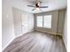 Bedroom featuring durable gray flooring, a ceiling fan, and a pair of bright windows at 102 Neal Ave, Stockbridge, GA 30281