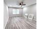 Spacious bedroom with contemporary flooring, a ceiling fan, and large windows at 102 Neal Ave, Stockbridge, GA 30281