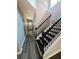 Hallway with wood-look flooring, neutral walls, white trim, and a view of a black and white staircase at 102 Neal Ave, Stockbridge, GA 30281
