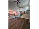 Living room with wood look flooring, neutral walls, white trim, and a view of the kitchen and staircase at 102 Neal Ave, Stockbridge, GA 30281