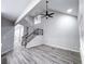 A spacious living room with high ceilings, modern flooring, and a staircase with dark metal railing at 102 Neal Ave, Stockbridge, GA 30281