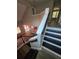 View of wooden staircase, foyer, and an open-concept kitchen and living area filled with natural light at 102 Neal Ave, Stockbridge, GA 30281