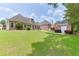 Expansive backyard featuring a well-maintained lawn, brick home, and an additional garage at 1125 Lewis Ridge Cir, Lawrenceville, GA 30045