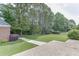 Spacious backyard with mature trees and a brick structure at 1125 Lewis Ridge Cir, Lawrenceville, GA 30045