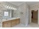Bathroom with floral wallpaper features double sinks, spacious vanity, and tile floors at 1125 Lewis Ridge Cir, Lawrenceville, GA 30045
