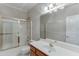 Bathroom featuring a shower-tub combo and a vanity with a large mirror at 1125 Lewis Ridge Cir, Lawrenceville, GA 30045