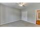Cozy bedroom with neutral carpet, ceiling fan, and a double door closet at 1125 Lewis Ridge Cir, Lawrenceville, GA 30045