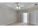 Large bedroom featuring soft neutral carpet, ceiling fan, and access to the Primary bathroom at 1125 Lewis Ridge Cir, Lawrenceville, GA 30045
