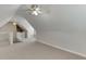 Upper level loft bonus room with neutral carpet and dual ceiling fans at 1125 Lewis Ridge Cir, Lawrenceville, GA 30045