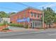 Two-story brick building featuring a bakery and eatery, complemented by landscaped greenery and street-side parking at 1125 Lewis Ridge Cir, Lawrenceville, GA 30045