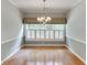 Elegant dining room with hardwood floors, chandelier, and plantation shutters at 1125 Lewis Ridge Cir, Lawrenceville, GA 30045
