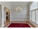 Bright dining room featuring hardwood floors, wainscoting, and a large window with plantation shutters at 1125 Lewis Ridge Cir, Lawrenceville, GA 30045