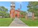 Gwinnett Historic Courthouse featuring a clock tower, well-manicured lawn, and historical marker at 1125 Lewis Ridge Cir, Lawrenceville, GA 30045
