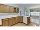 Kitchen featuring wood cabinets, white countertops and view of dining room at 1125 Lewis Ridge Cir, Lawrenceville, GA 30045