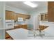 Fully equipped kitchen with white countertops, wooden cabinets, and wood flooring at 1125 Lewis Ridge Cir, Lawrenceville, GA 30045