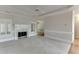 Comfortable living space with a fireplace, neutral carpeting, and bright plantation shutters at 1125 Lewis Ridge Cir, Lawrenceville, GA 30045
