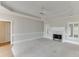 Spacious living room with a tray ceiling, cozy fireplace, and plantation shutters for natural light at 1125 Lewis Ridge Cir, Lawrenceville, GA 30045