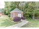 Exterior view of brick outbuilding, surrounded by lush greenery and landscaping at 1125 Lewis Ridge Cir, Lawrenceville, GA 30045