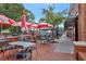 Inviting outdoor dining area with Coca-Cola umbrellas, tables, and chairs on a brick-paved patio creating a relaxing ambiance at 1125 Lewis Ridge Cir, Lawrenceville, GA 30045
