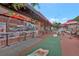 Lively restaurant exterior with outdoor seating, Coca-Cola umbrellas, and vibrant decor on a brick-paved sidewalk at 1125 Lewis Ridge Cir, Lawrenceville, GA 30045
