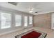 Light filled sun room with brick accent wall, tile floors, and backyard views at 1125 Lewis Ridge Cir, Lawrenceville, GA 30045