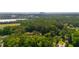 An expansive aerial view showcasing the lush greenery, surrounding landscape, and mountain background at 1671 Drayton Woods Dr, Tucker, GA 30084