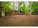 Expansive backyard with mature trees and a view of the home's deck and screened-in porch at 1671 Drayton Woods Dr, Tucker, GA 30084