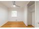 Cozy bedroom features hardwood floors, a closet, and a ceiling fan, bathed in natural light at 1671 Drayton Woods Dr, Tucker, GA 30084