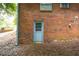 Home exterior features a brick facade and a convenient access door to the backyard at 1671 Drayton Woods Dr, Tucker, GA 30084