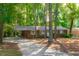 Lovely one-story brick home featuring a carport, landscaping, and mature trees at 1671 Drayton Woods Dr, Tucker, GA 30084